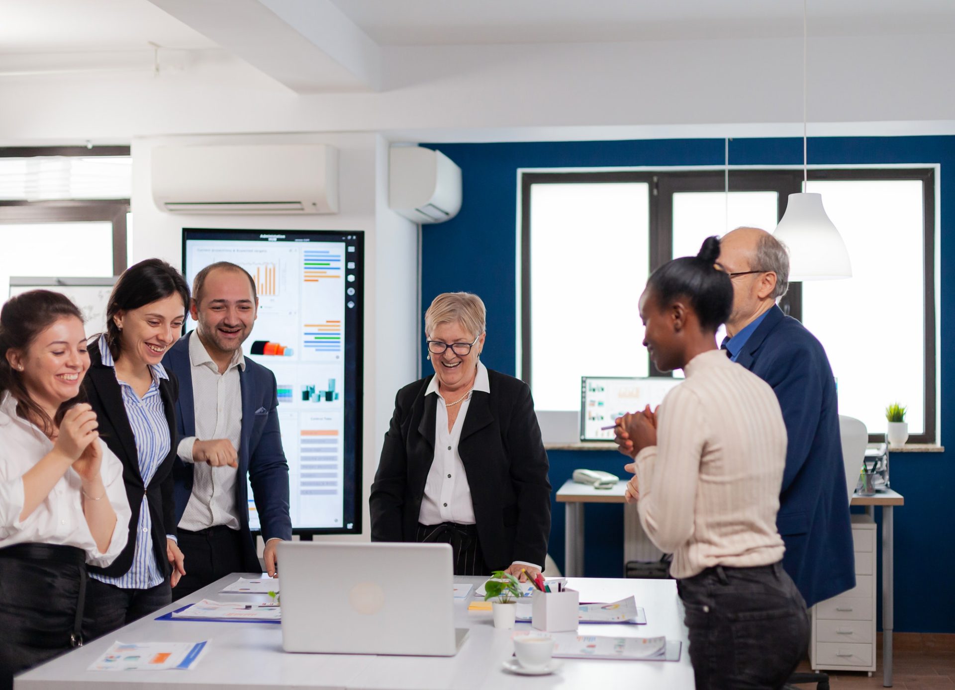 Financial corporate team overjoyed in conference room